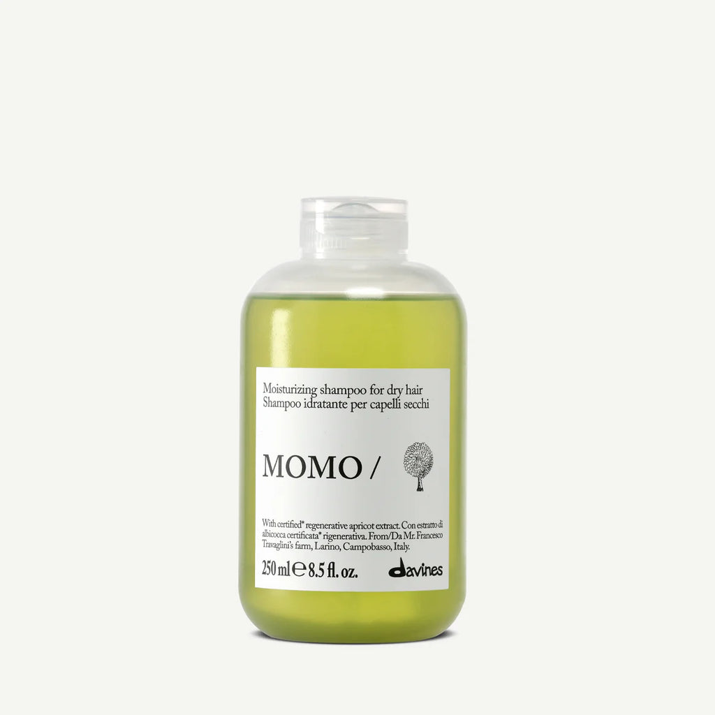 Shampoo bottle labeled 'MOMO/' on a white background